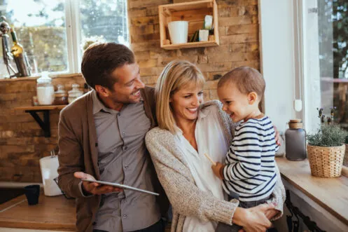 Parents and a toddler relaxing at home together